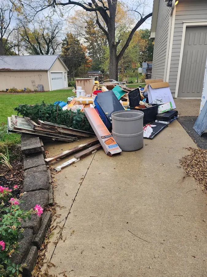 Dumpster being loaded with debris for 3 Yard Dumpster Rental in Holladay